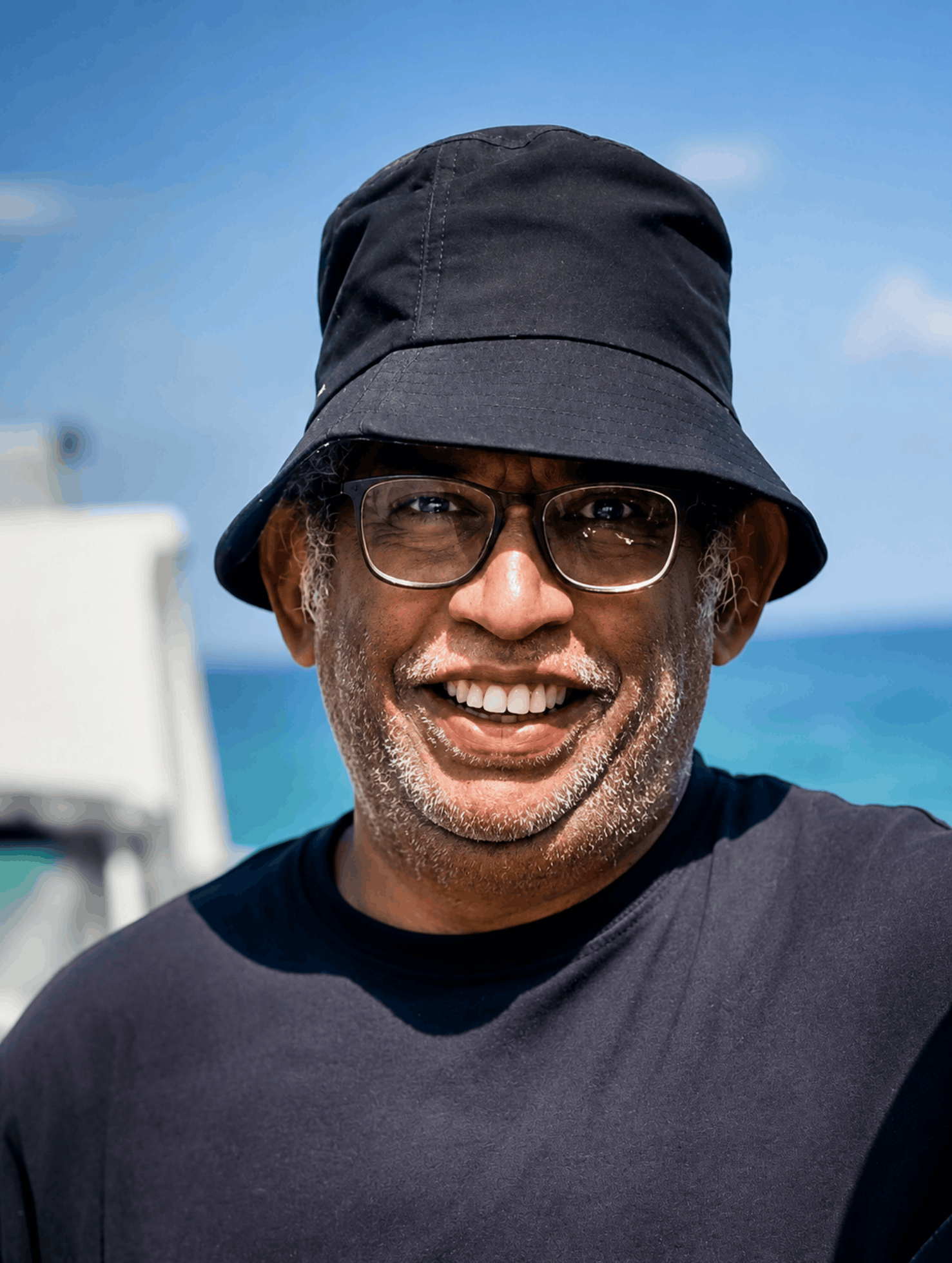 Lakmin, dive specialist and personal dive planner, smiling on the boat
